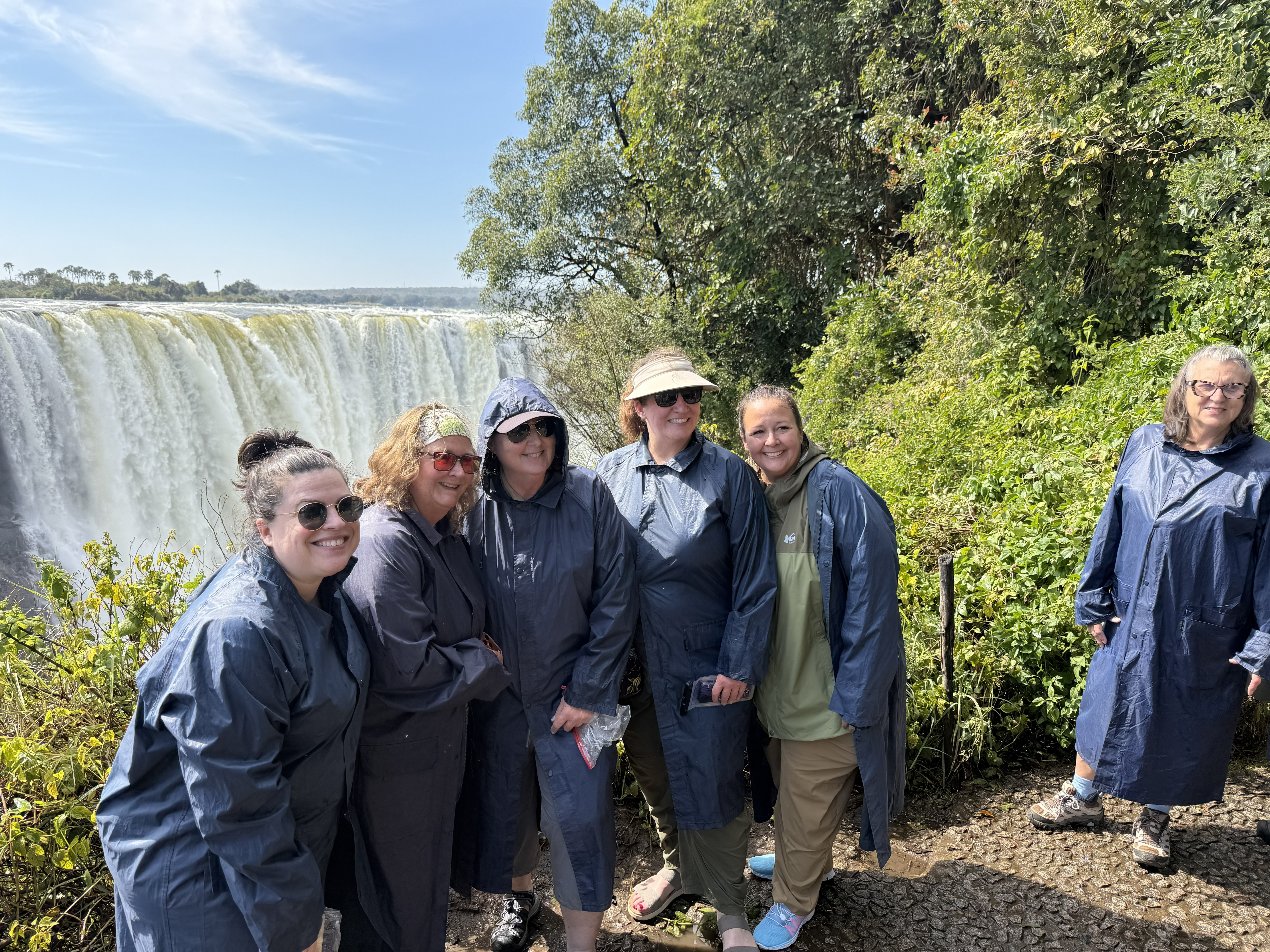 The women of the group — Natasha, Debra, Tara, Meredith, Kirsten, and Kathryn — at the start of the walk, before the spray got everybody. They all knew each other before this trip;
