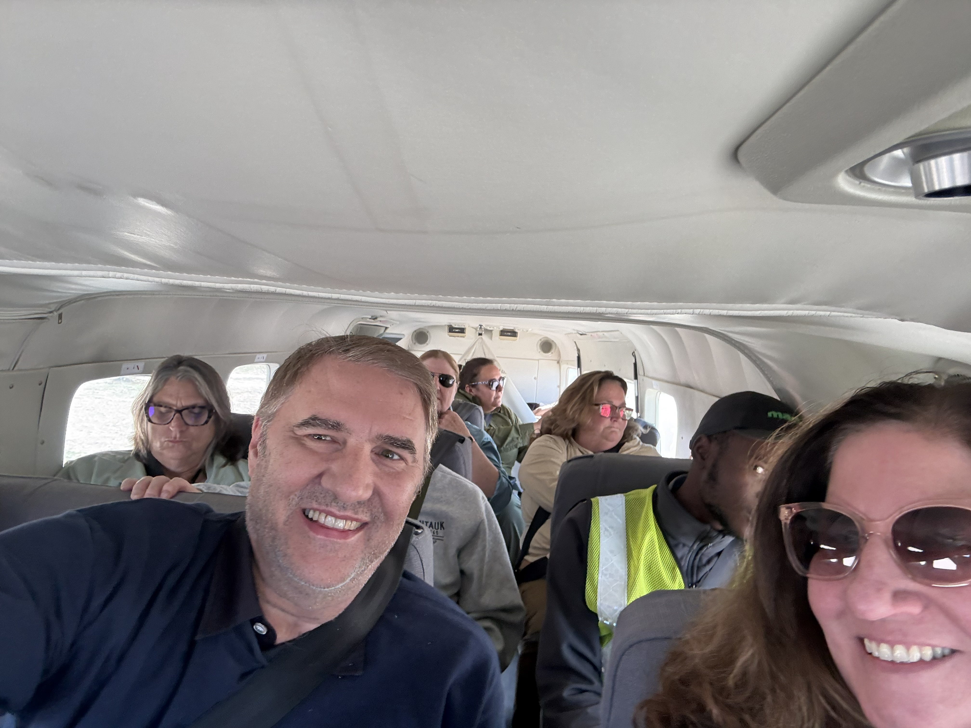 Back in the bush plane, Bonnie and me and the rest of the group folded in among the duffel bags. The same tiny aircraft, the same knees-together grins — only this time pointed the