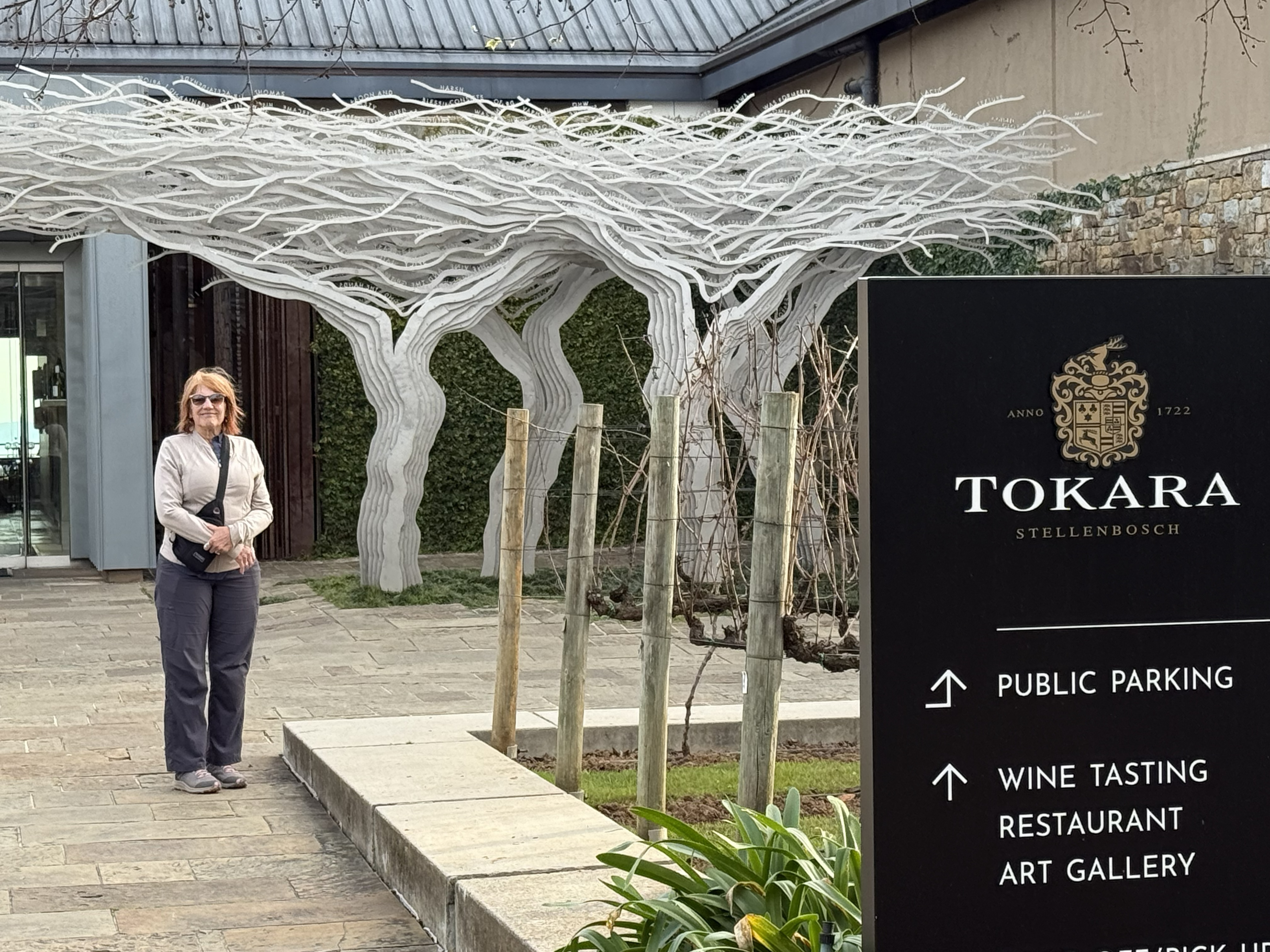 The sign at the entrance — public parking, wine tasting, restaurant, art gallery. A different sort of operation entirely.
